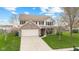 Inviting two-story house with brick accents, a two-car garage, and a pristine front lawn at 3130 Shadow Lake Dr, Indianapolis, IN 46217
