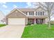 Charming two-story home with brick accents, attached garage, and well-manicured front lawn at 3130 Shadow Lake Dr, Indianapolis, IN 46217