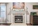 Living room fireplace with stone surround and a decorative mantle, paired with a wooden American flag wall hanging at 3130 Shadow Lake Dr, Indianapolis, IN 46217