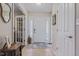 Bright foyer with tile flooring, a decorative rug, and a view into other rooms at 3130 Shadow Lake Dr, Indianapolis, IN 46217