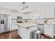 Well-lit kitchen featuring stainless steel appliances, tile backsplash, and a functional center island at 3130 Shadow Lake Dr, Indianapolis, IN 46217