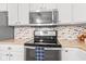 Modern kitchen featuring stainless steel microwave and oven with sleek countertops at 3130 Shadow Lake Dr, Indianapolis, IN 46217