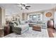 Spacious living room with a large sectional sofa, hardwood floors, and a view of the kitchen and dining area at 3130 Shadow Lake Dr, Indianapolis, IN 46217