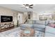 Comfortable living room with an oversized sectional sofa and views into the dining area and staircase at 3130 Shadow Lake Dr, Indianapolis, IN 46217