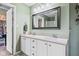 Bathroom featuring a double vanity with white cabinets and large framed mirror at 3130 Shadow Lake Dr, Indianapolis, IN 46217