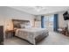 This bedroom features a large bed, soft carpet, and a window that offers natural lighting at 3130 Shadow Lake Dr, Indianapolis, IN 46217