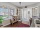 Sunlit home office featuring hardwood floors, built-ins, french doors, and a window with a view of the outdoors at 3130 Shadow Lake Dr, Indianapolis, IN 46217