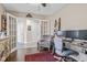 Bright home office with french doors, desk, plush chair, rustic shelving, and a ladder displaying throws at 3130 Shadow Lake Dr, Indianapolis, IN 46217