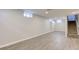 Finished basement featuring modern flooring, neutral walls, and carpeted stairs to the upper level at 334 N 15Th Ave, Beech Grove, IN 46107