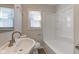 Bathroom with white fixtures, updated vanity and a shower-tub combo at 334 N 15Th Ave, Beech Grove, IN 46107