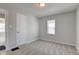 Bedroom with neutral walls, carpet, a window and a door at 334 N 15Th Ave, Beech Grove, IN 46107