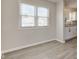 Bright dining area featuring new flooring and white trim, bathed in natural light from the windows at 334 N 15Th Ave, Beech Grove, IN 46107
