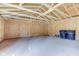 Unfinished garage interior showing wood framing, concrete floor, and trash bins at 334 N 15Th Ave, Beech Grove, IN 46107