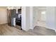 The kitchen features stainless steel appliances and white cabinets, flowing into the carpeted living area at 334 N 15Th Ave, Beech Grove, IN 46107