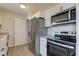 The updated kitchen has stainless steel appliances, including a refrigerator, microwave and oven range at 334 N 15Th Ave, Beech Grove, IN 46107