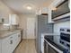 The kitchen features stainless steel appliances, granite countertops, and white cabinetry at 334 N 15Th Ave, Beech Grove, IN 46107
