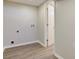 Laundry room features new vinyl floors, easy access for hookups, and a doorway to the rest of the basement at 334 N 15Th Ave, Beech Grove, IN 46107