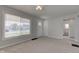 Bright living room features neutral paint, ceiling fan, and large window with blinds for natural light at 334 N 15Th Ave, Beech Grove, IN 46107