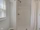 Bright and modern shower featuring white subway tiles and complemented by a shower curtain for privacy at 334 N 15Th Ave, Beech Grove, IN 46107