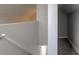 A bright stairway provides access to different levels, complemented by neutral walls and carpeting at 334 N 15Th Ave, Beech Grove, IN 46107