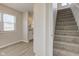 Carpeted stairs lead to the upper level, offering an inviting view into a naturally-lit living area at 334 N 15Th Ave, Beech Grove, IN 46107