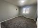 A cozy bedroom with gray walls, plush carpet, and a window bringing in natural light at 3413 Ivory Way, Indianapolis, IN 46227