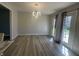 Bright dining area with modern light fixture, new flooring, and sliding door access to backyard at 3413 Ivory Way, Indianapolis, IN 46227