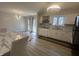 Spacious dining area with modern lighting, new flooring, and access to the backyard at 3413 Ivory Way, Indianapolis, IN 46227