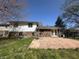 The back of a brick and white home, featuring a patio area and well-maintained yard at 3413 Ivory Way, Indianapolis, IN 46227