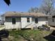 Back of the house, showing the siding, windows, and some items stored in the yard at 3751 Creston Dr, Indianapolis, IN 46222