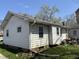 Rear view of the property showcasing siding and windows, with outdoor equipment nearby at 3751 Creston Dr, Indianapolis, IN 46222
