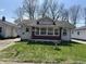 Charming home featuring red brick accents on the front porch area and a well-maintained lawn at 3751 Creston Dr, Indianapolis, IN 46222
