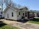 Home exterior showing white siding and a small porch area with entrance on the side at 3751 Creston Dr, Indianapolis, IN 46222