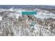 Scenic aerial view of a snow-covered Painted Hills lake community in winter at 3764 E Glenwood Dr, Martinsville, IN 46151