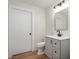 Bathroom with gray vanity, white toilet, and updated lighting fixtures at 3764 E Glenwood Dr, Martinsville, IN 46151