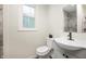 Bathroom featuring a modern vanity, toilet, mirror, and window for natural light at 3764 E Glenwood Dr, Martinsville, IN 46151