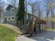 Charming two story home with elevated deck and staircase surrounded by lush green landscaping at 3764 E Glenwood Dr, Martinsville, IN 46151