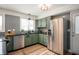 Bright kitchen with stainless steel appliances, sleek black countertops, and contemporary fixtures at 3764 E Glenwood Dr, Martinsville, IN 46151