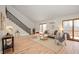 Open-concept living room with vaulted ceilings, hardwood floors, and sliding glass doors at 3764 E Glenwood Dr, Martinsville, IN 46151