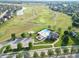 Aerial view of a community pool, playground, and a nearby golf course at 3789 Shady Pointe Row, Greenwood, IN 46143