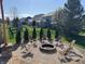 Landscaped backyard with a charming stone fire pit and Adirondack chairs at 3789 Shady Pointe Row, Greenwood, IN 46143