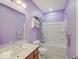 Clean bathroom featuring purple walls, a shower-tub combo, and wooden vanity at 3789 Shady Pointe Row, Greenwood, IN 46143