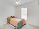 Cozy bedroom with a colorful quilt, ceiling fan, and bright natural light at 3789 Shady Pointe Row, Greenwood, IN 46143
