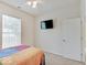 This bedroom features a flat screen TV, ceiling fan, and bright natural light at 3789 Shady Pointe Row, Greenwood, IN 46143