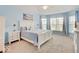 Comfortable bedroom featuring a large bed, white furniture, a ceiling fan and large windows at 3789 Shady Pointe Row, Greenwood, IN 46143