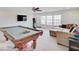 Large bonus room with pool table, workout equipment, and bright natural light at 3789 Shady Pointe Row, Greenwood, IN 46143