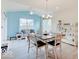 Cozy dining area with modern table, bright blue accent wall, and plenty of natural light at 3789 Shady Pointe Row, Greenwood, IN 46143