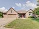 Charming single-story brick home with manicured lawn, arched windows, and a welcoming covered porch at 3789 Shady Pointe Row, Greenwood, IN 46143