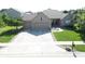 A single-story brick home featuring a three-car garage and a well-maintained lawn, viewed from an aerial perspective at 3789 Shady Pointe Row, Greenwood, IN 46143