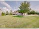 Well-manicured front yard of a brick home with mature trees at 3789 Shady Pointe Row, Greenwood, IN 46143